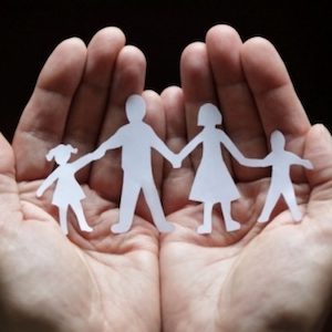 Family paper dolls held in palm of hands Family paper dolls held in palm of hands